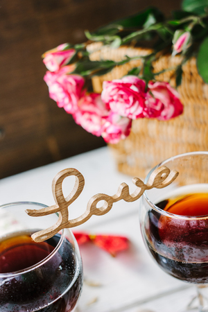 Wooden word LOVE standing on glasses of wine.の写真素材