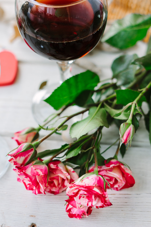 Flowers and glasses of wine on celebration of Valentine's day.の写真素材