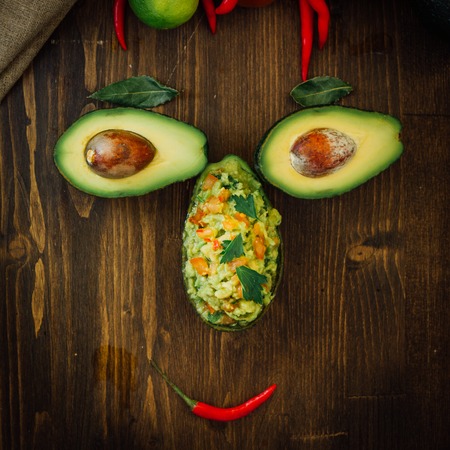 Funny food face made from avocado and guacamole dipの写真素材