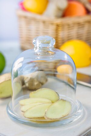 Slices of ginger root covered by glass coverの写真素材