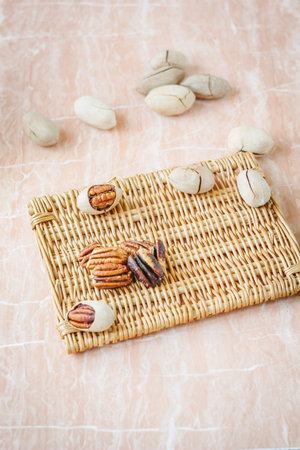 Nice pecan nuts over pink plastic board