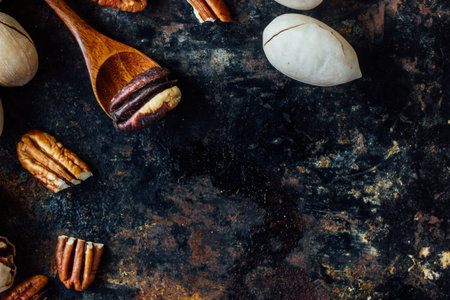 Pecan nut and wooden spoon on rustic table