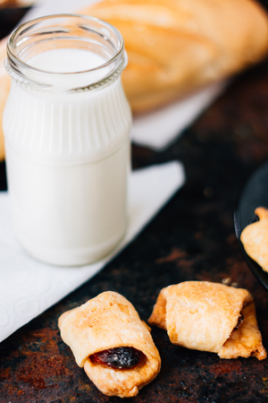 Nice breakfast - milk with croissants on black rustic surfaceの写真素材