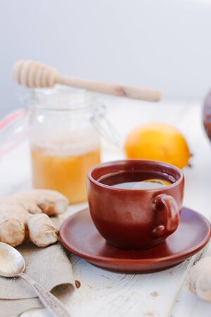 Ginger tea with lemon, lime and honey on whiteの写真素材