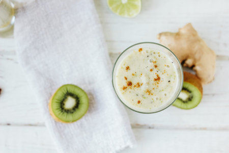 Fresh smothie - vegan drink with banana, salad leaves, ginger and kiwiの写真素材