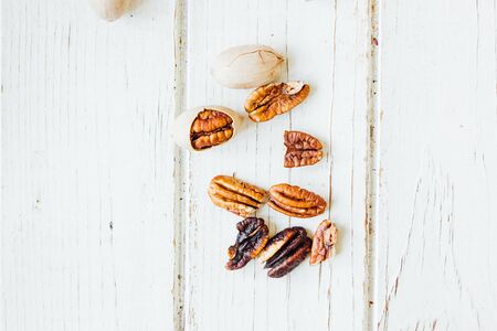 Natural pecan nuts on white wooden tableの写真素材