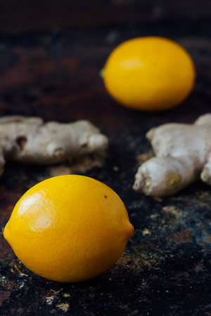 Lemon and ginger root on black rustic surface.の写真素材