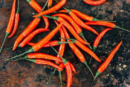 Red hot chili peppers over rustic surface - fresh and organic