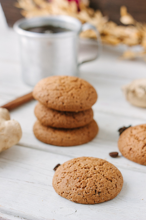 Ginger snaps on white wooden surface with spices around.の写真素材