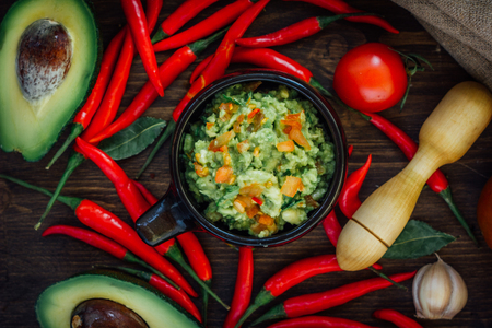 Top view of traditional mexican guacamole and its ingredientsの写真素材