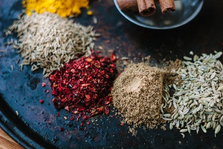 Set of different spices over black metal plateの写真素材