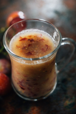 Grape smoothie over the black metal board.