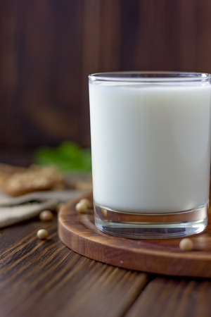 Soybean milk with soy beans around itの写真素材