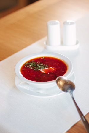 Beautiful russian national soup - borscht at white plate.