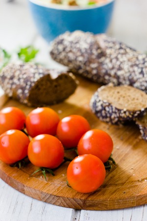 Bunch of cherry tomatoes over wooden boardの写真素材