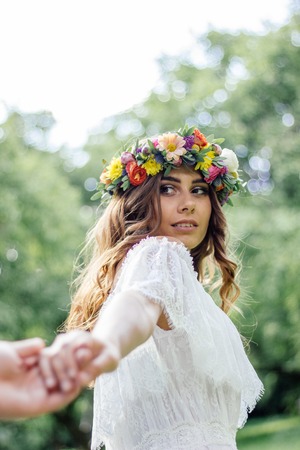 Young woman in white wedding dress carry away a man.の写真素材