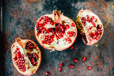 Parts of pomegranate fruit on black rustic sufrace.の写真素材