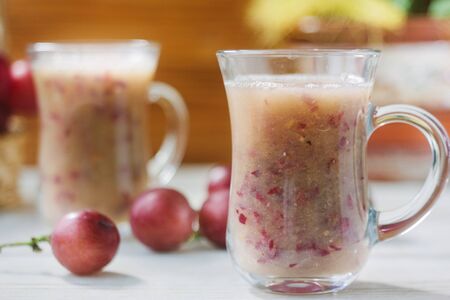 Grape smoothie over the white table.の写真素材