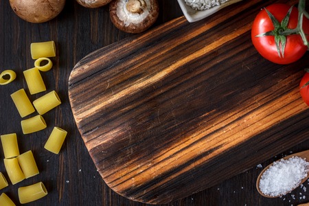 kitchen board with vegetables and spices around. Place for your text.の写真素材