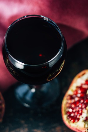 Fresh pomegranate juice in glass over black background.の写真素材