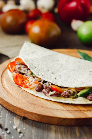 Mexican food - vegetarian quesadilla on wooden board.の写真素材