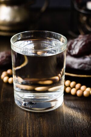 Iftar water for Ramadan fast opening on black table.の写真素材