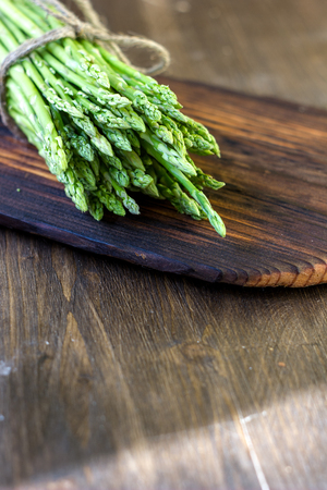 Hip of asparagus laying on wooden boardの写真素材