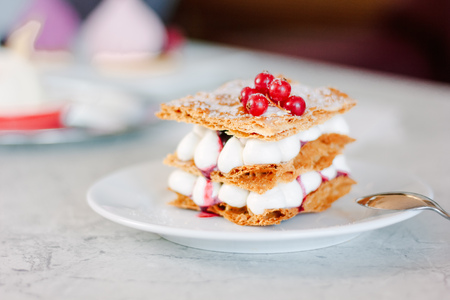 Layered cream dessert Millefeuille with vanilla cream and red berries.の写真素材