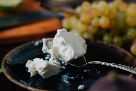 Ricotta cheese on black ceramic plate with grapes ready to eatの写真素材