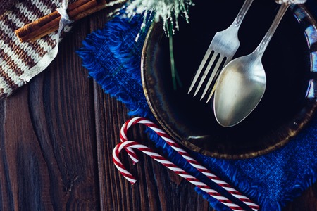 Christmas menu: decoration of christmas table - fork, spoon and plate with some christmas attributesの写真素材