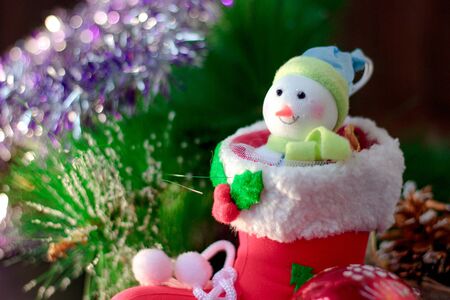 Christmas snowman sitting inside red christmas bootの写真素材