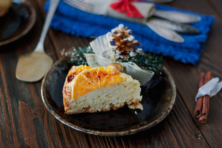 A christmas cake on black plate over the wooden table.