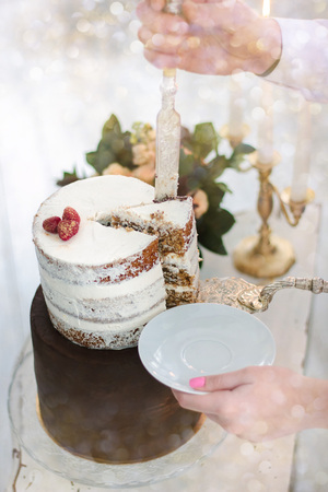 Hand with knife cutting christmas cake during celebrationの写真素材