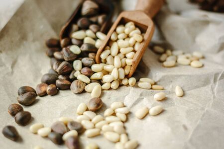 Two kinds of pine nuts - with shell and without shellの写真素材