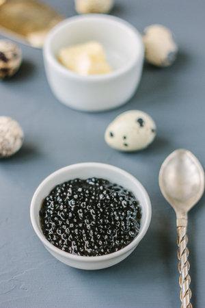 A black caviar in a white ceramic bowl.の写真素材