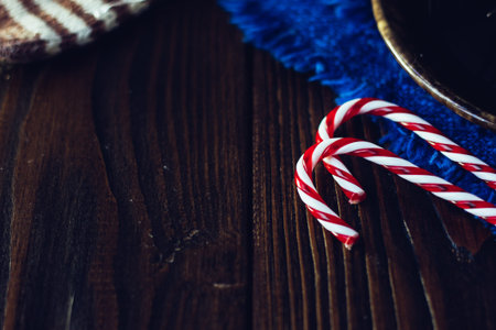 Top view of christmas candy canes on the wooden background.の写真素材