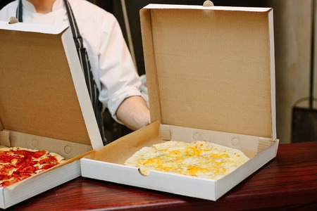 Pizza in craft cardboard box ready for delivery.の写真素材