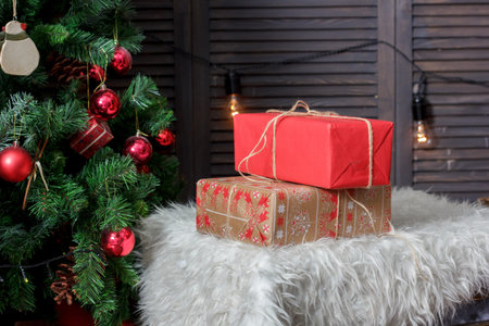 Red gift boxes near the christmas tree during christmas celebration.の写真素材