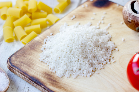 Kitchen board with a dry raw riceの写真素材