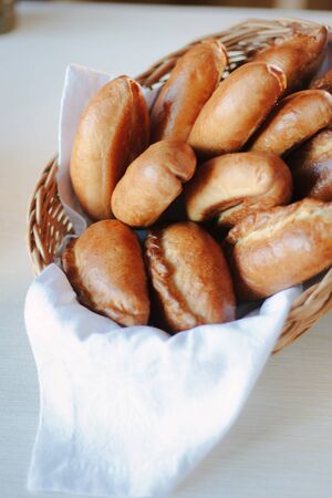 Delicious pastries on basket over white table.の写真素材