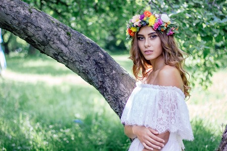 Wedding background. Bride in wedding dress with flower wreath on hairs.の写真素材