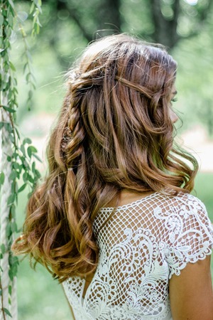 Beautiful wedding hairstyle with the bride turning back.の写真素材