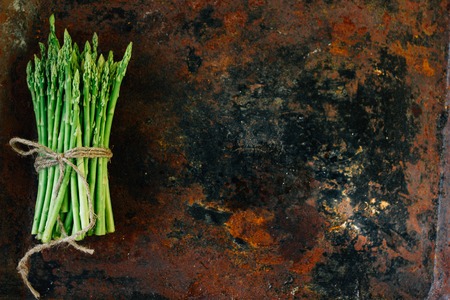 Hip of fresh asparagus on metal rustic board.の写真素材