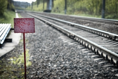 Red nameplate against rails for text or numbers.の写真素材