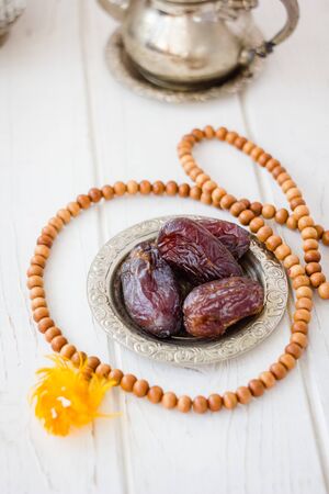 Dates on metal plate as iftar food during Ramadan month.の写真素材