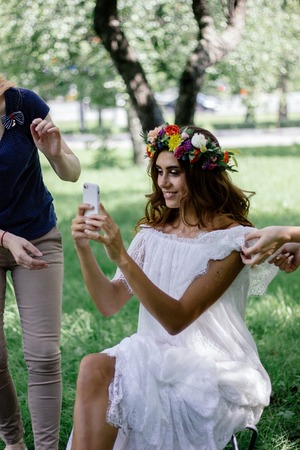 Beautiful bride making selfie during the make up session.の写真素材