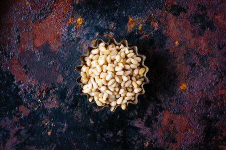 Top view of pine nuts over the rusty backgroundの写真素材