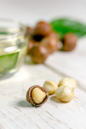 Nice macadamia nuts on the white wooden tableの写真素材