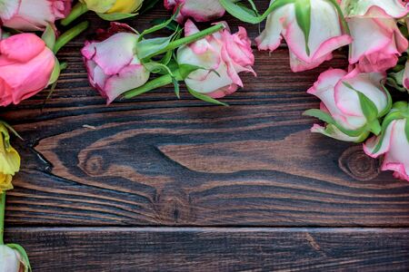 Roses frame on wooden background. Flowers on woodの写真素材