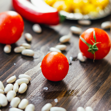 Red ripe Cherry tomatoes on a wooden table.の写真素材